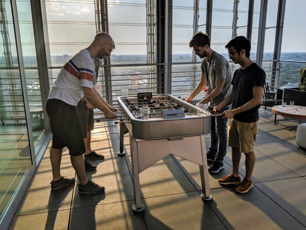 Developers playing foosball on a rooftop terrace
