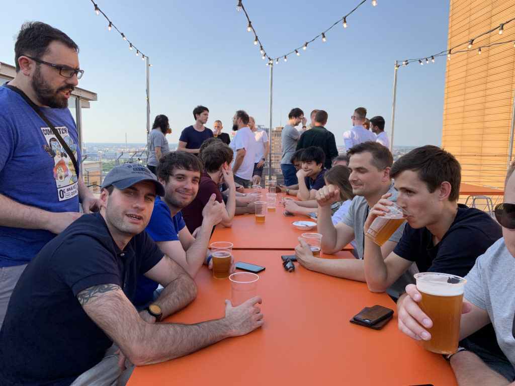 Developers sitting on a rooftop terrace drinking beer